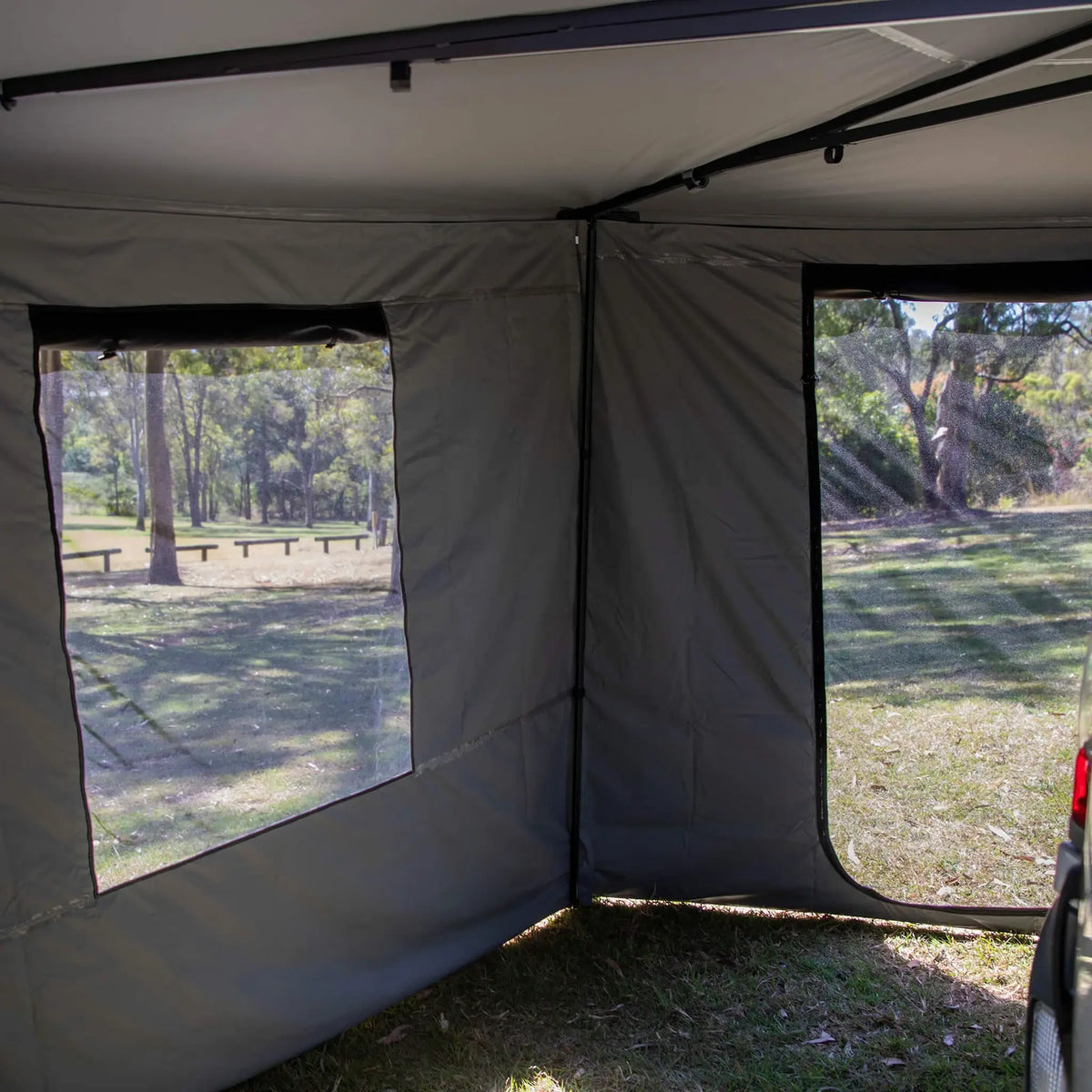 Bushwakka Extreme 270 awning wall kit interior corner with clear windows and open doorway.