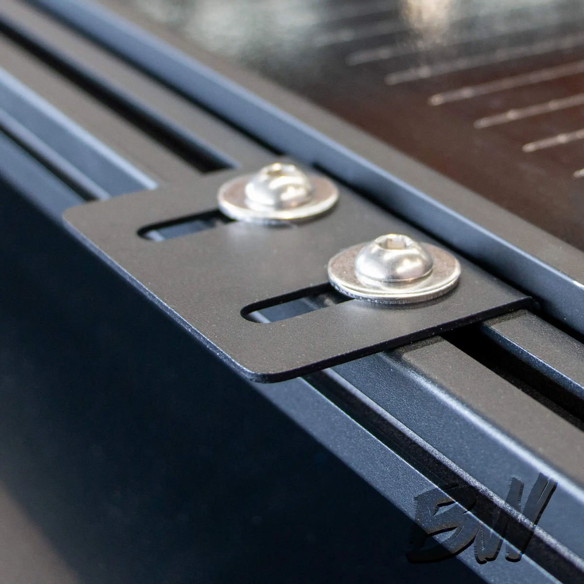 Bushwakka Solar Panel Mounting Plate fitted to a Roam Gear solar panel and mounted to a roof rack rail.