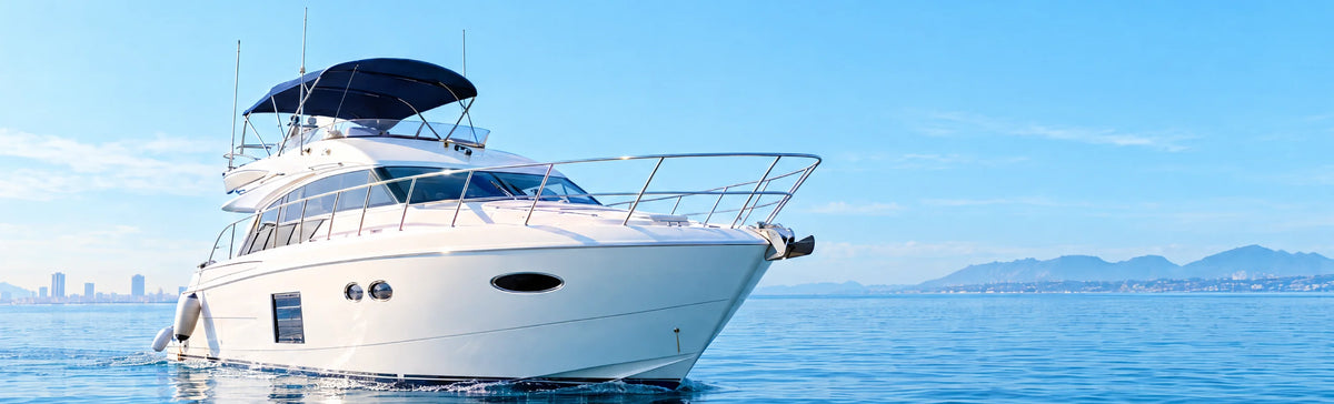Motor cruiser under way on calm water with a coastline behind
