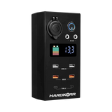 Small Hardkorr 12V DC power distribution box front view with a battery level display, USB ports and covered socket.