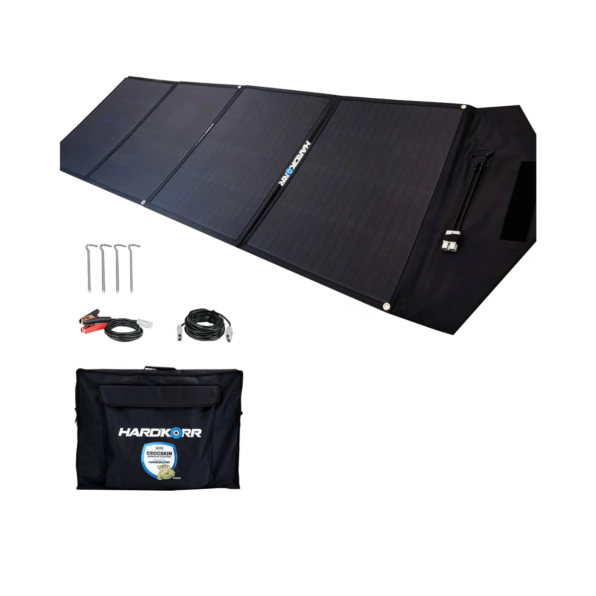 Hardkorr 200W 12V portable solar mat unfolded beside its carry bag, pegs and positive and negative battery clamp lead.