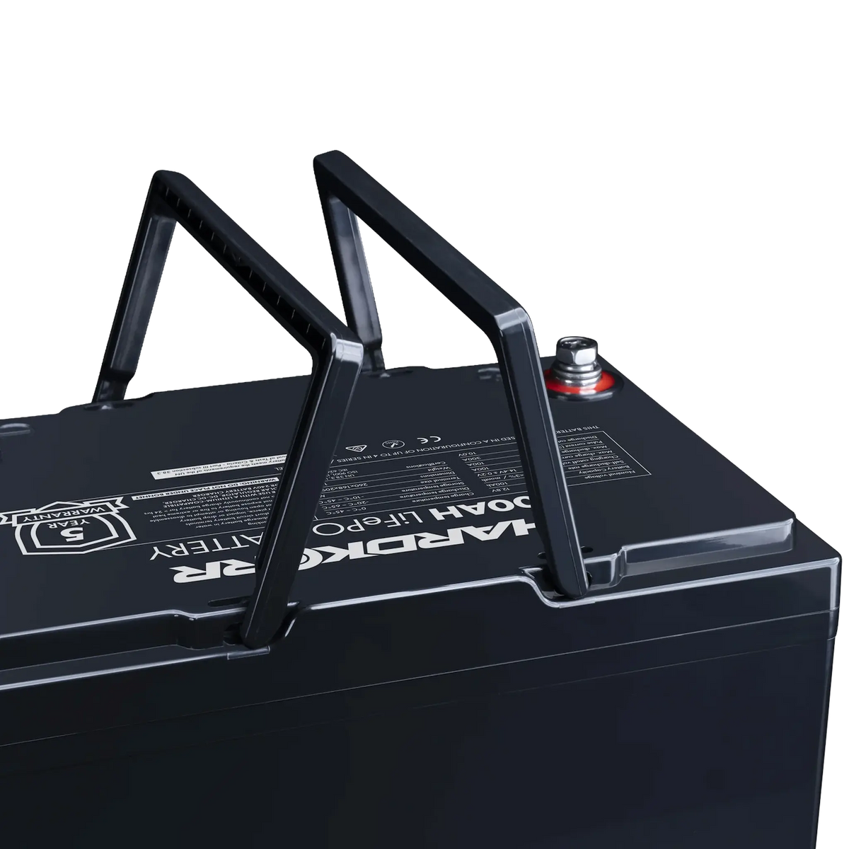 Hardkorr Black 100Ah 12V lithium battery close up of raised carry handles and positive terminal.