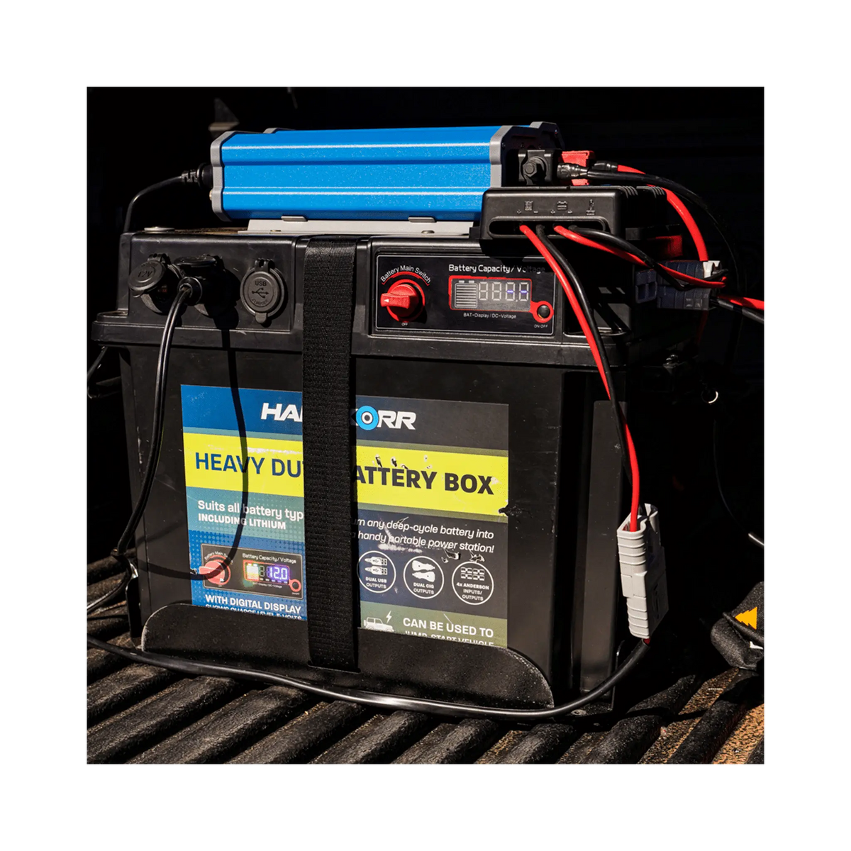 Black Hardkorr battery box strapped in a ute tray with positive and negative cables attached.