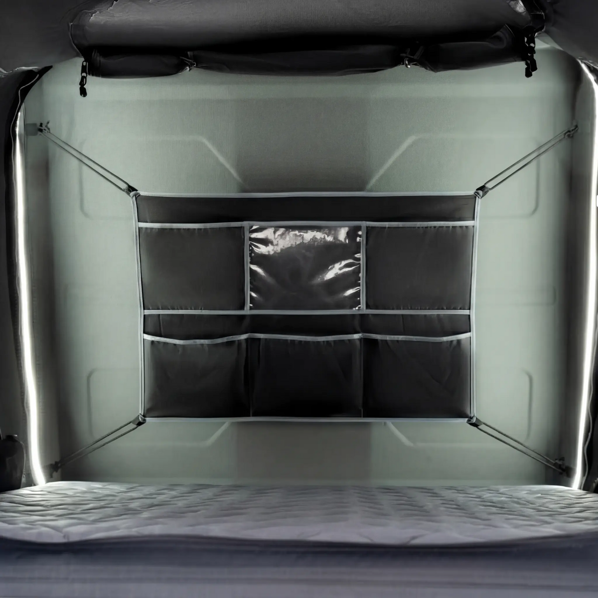 Outback Tourer 1.5 Lite Rooftop Tent interior view with mattress and organiser pockets.