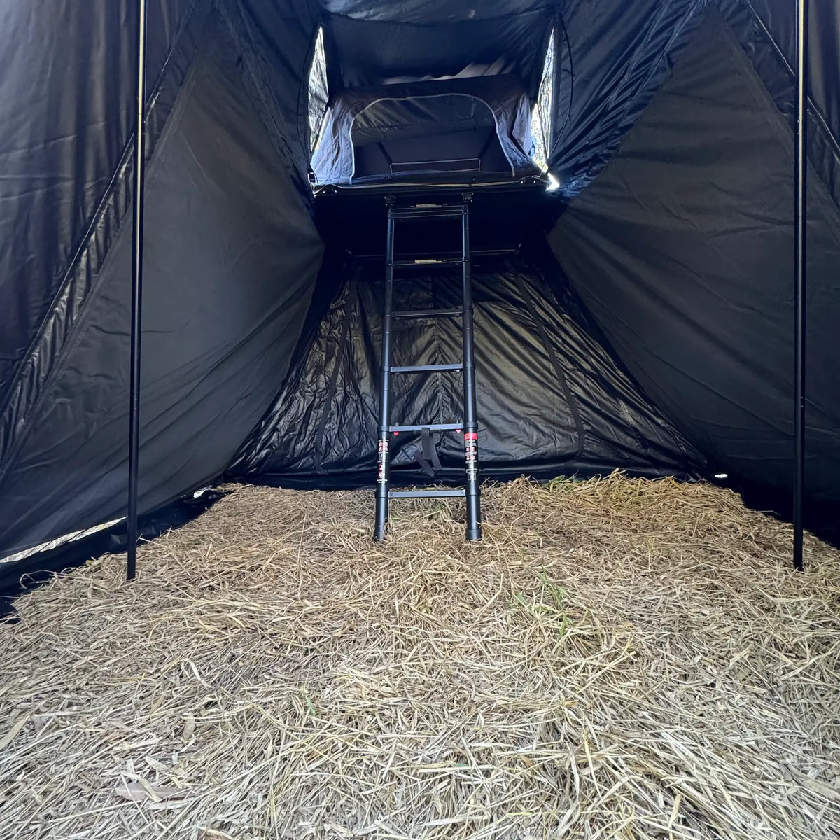 Outback Tourer 1.5 Pro Annex close interior view with ladder and rooftop tent opening.