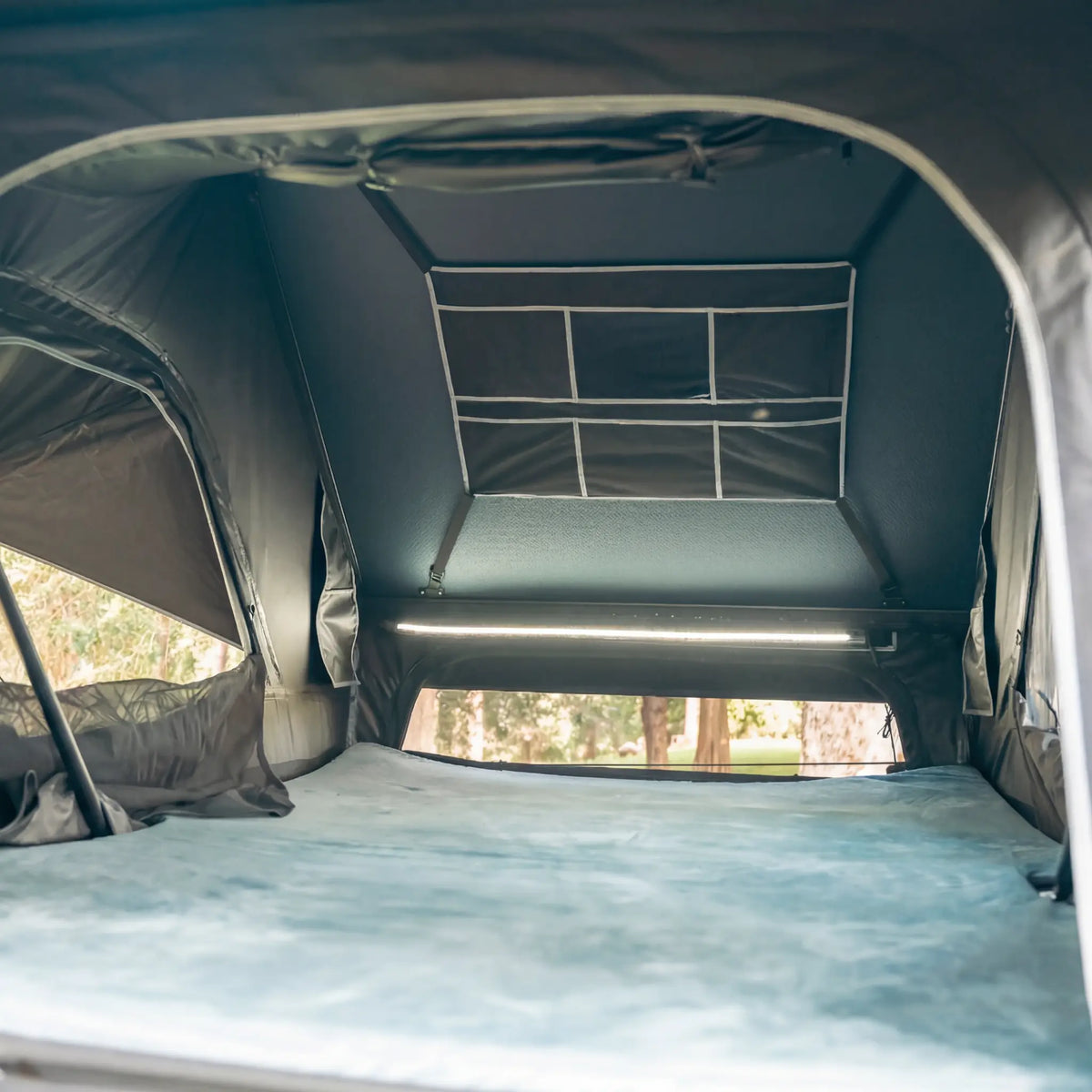 Outback Tourer 1.5 Pro Rooftop Tent interior view with mattress, LED light and windows open.