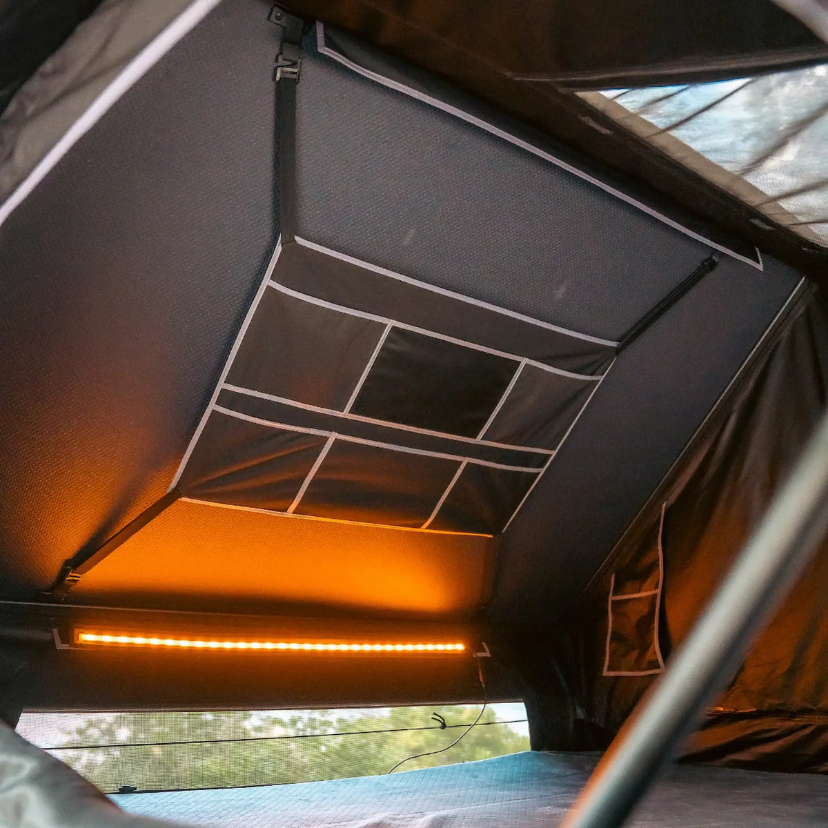 Outback Tourer 1.9 Pro Rooftop Tent interior organiser pockets above the bed area.