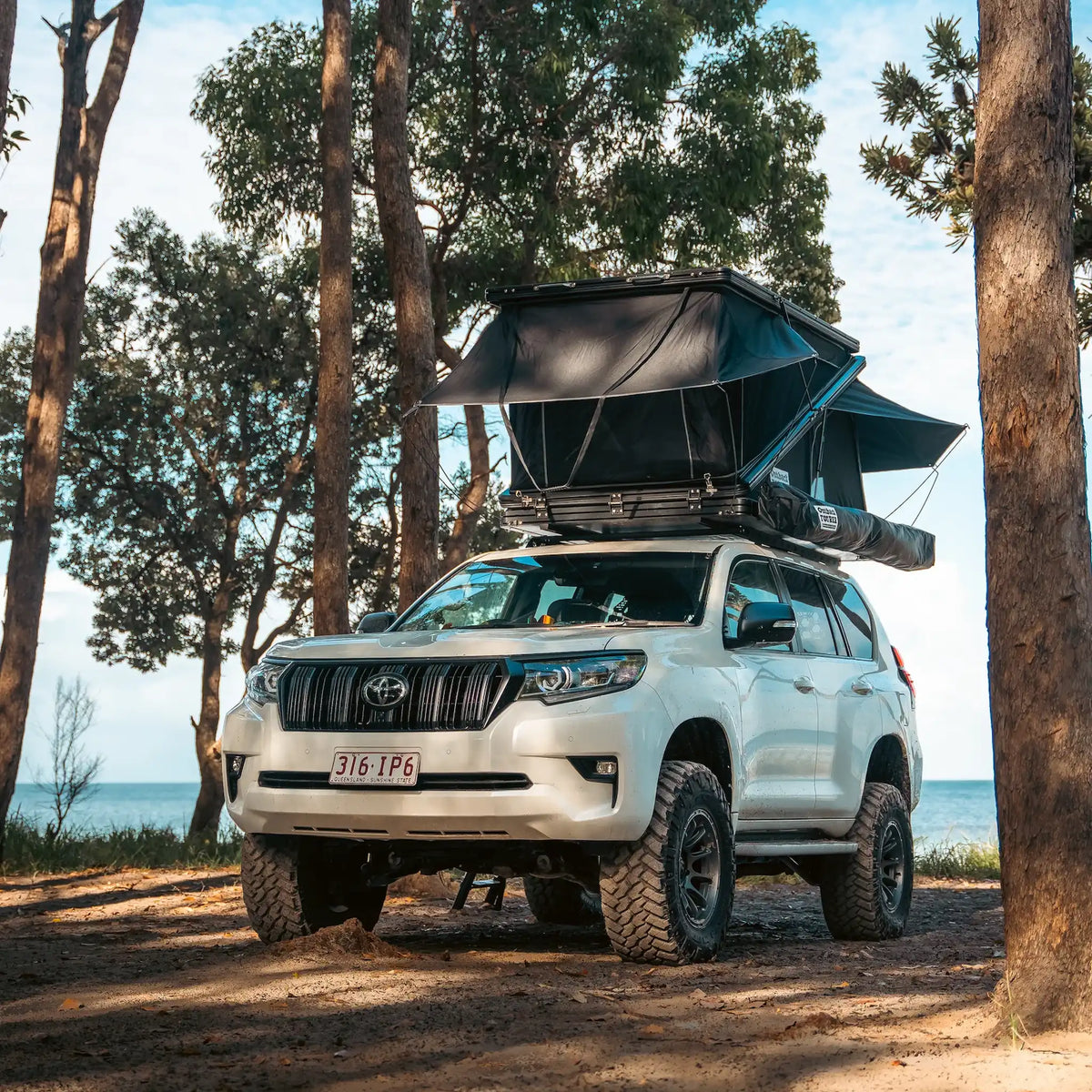 Outback Tourer 1250 Z Rooftop Tent front right installed view on a prado at Moreton Island.