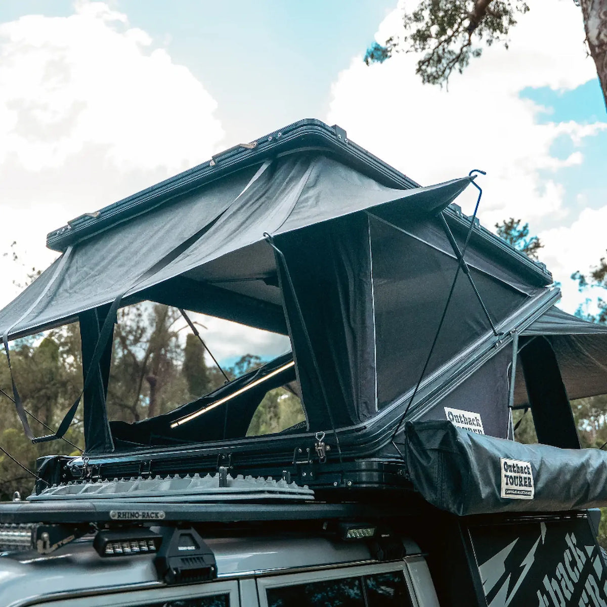 Outback Tourer 1550 Z Rooftop Tent open front right installed above the vehicles canopy.
