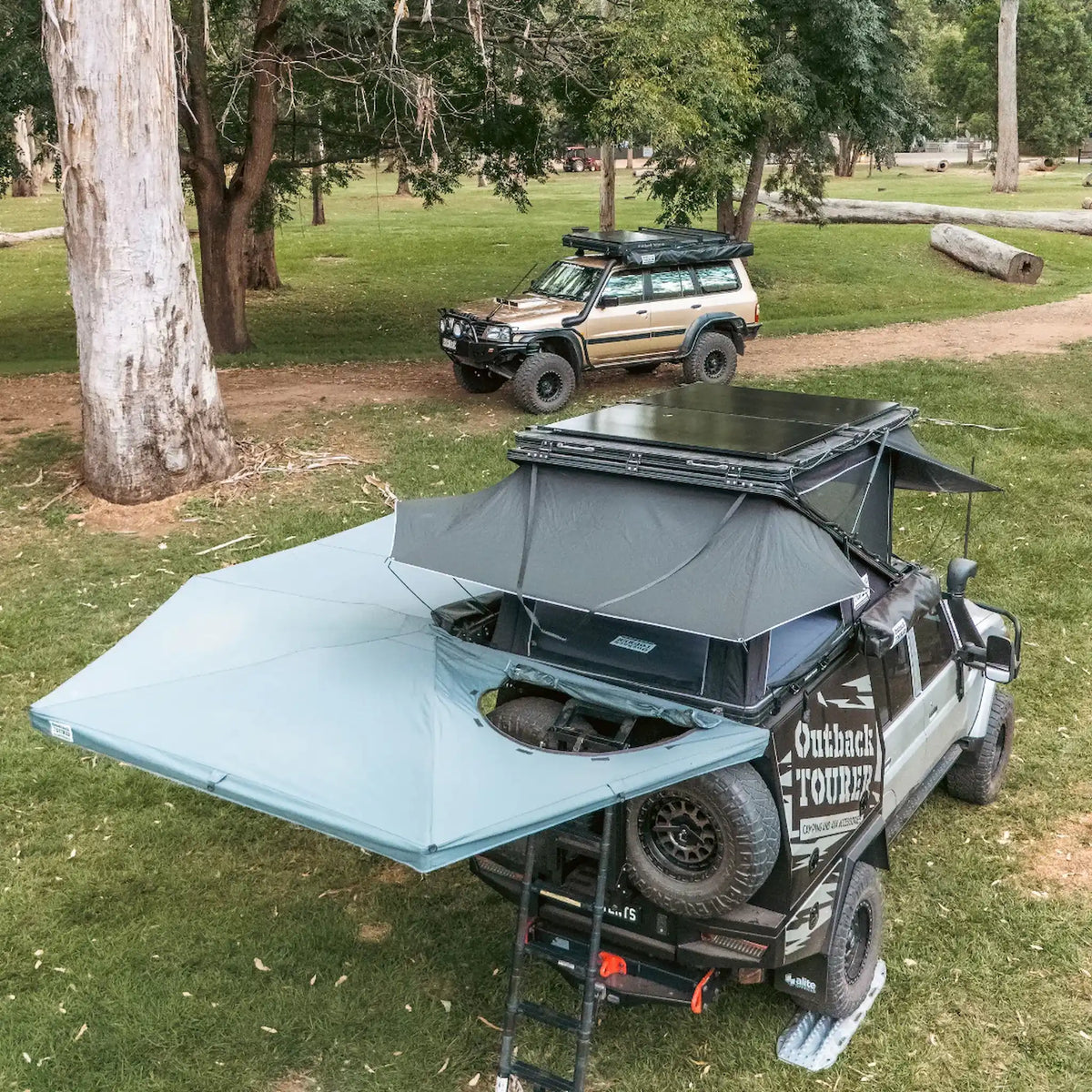 Outback Tourer Passenger Side 270 Plus with D Zipper Awning rear top view with rooftop tent open and solar view.