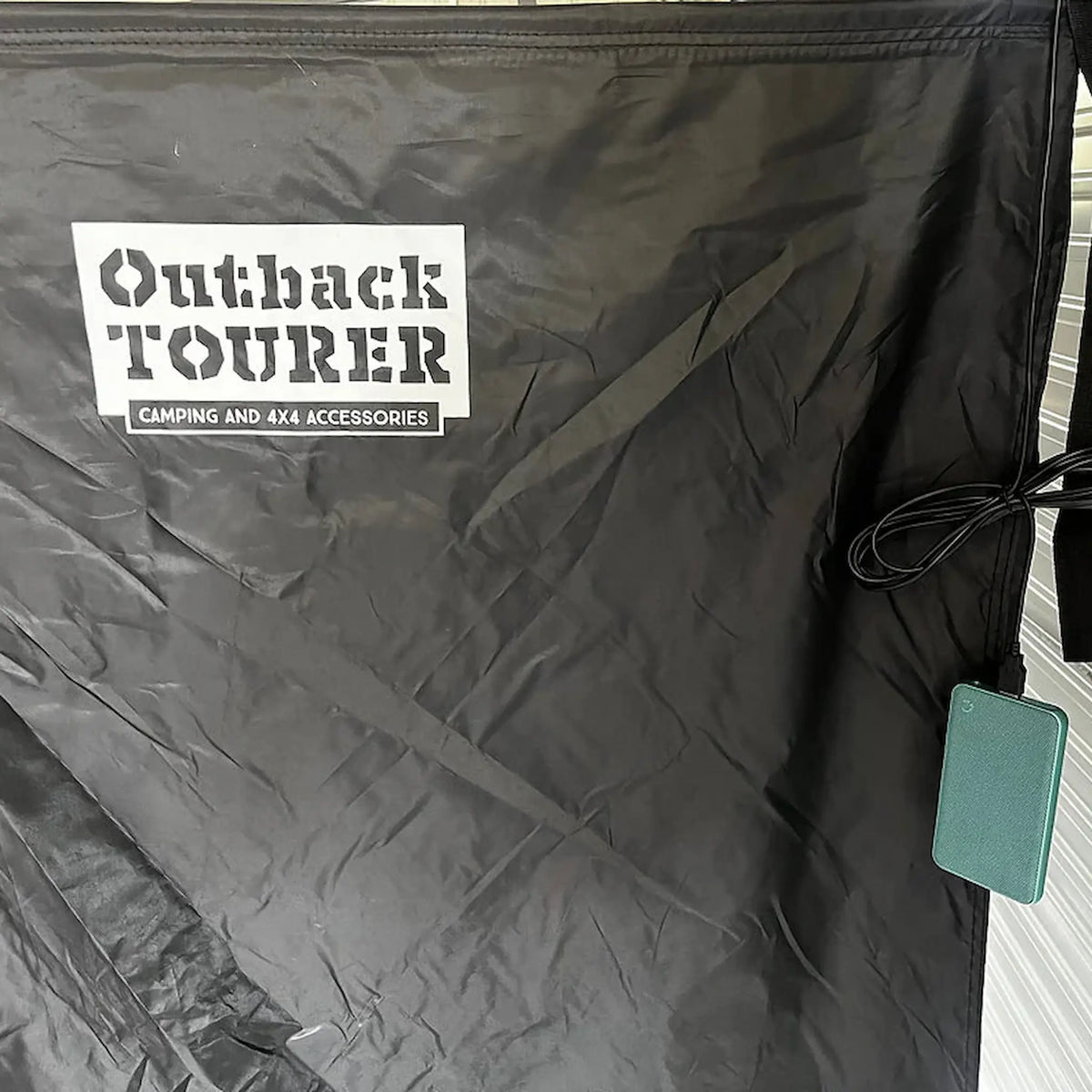 Outback Tourer Shower Awning logo with a hanging power bank for the LED lights.