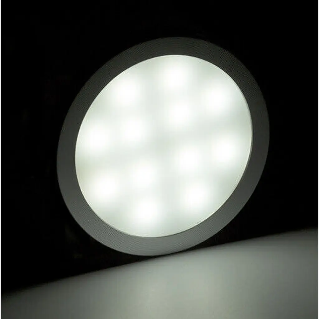 Rekcharge 12V silver cool white LED downlight casting soft white light onto the surface below.