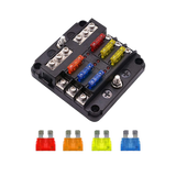 Rekcharge 6 way fuse block with coloured blade fuses fitted and four loose fuses laid out below.