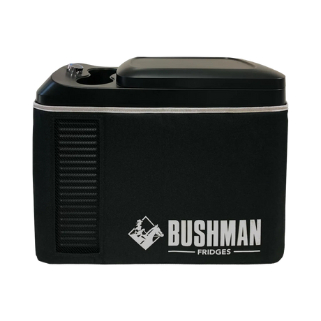 Bushman Roadie 15L portable fridge freezer side view with a white logo, ventilation slots and carry bag.