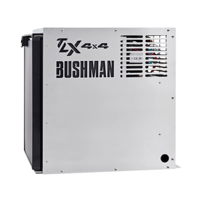 Bushman 65L aluminium fridge box right side view with vent slots and cutout logos beside a black fridge door.