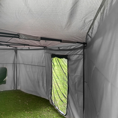 Bushwakka Extreme Darkness awning wall kit interior view showing a mesh door, roof supports and grey walls.