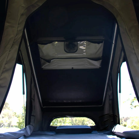 Bushwakka Doghouse rooftop tent interior view showing the mattress, side windows and ceiling fan.