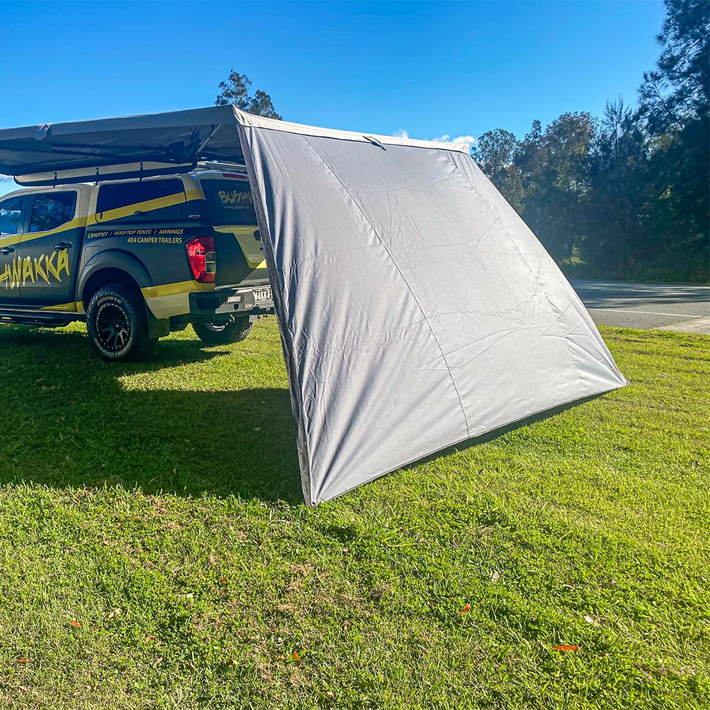 Bushwakka Extreme 180 degree awning wall rear angled exterior view with the grey panel extended to the ground.