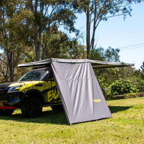 Bushwakka Extreme 2000 mm straight wall front-left installed view beneath a vehicle awning.