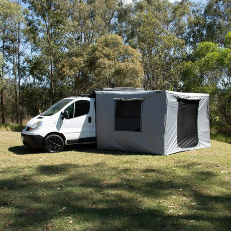 Bushwakka Extreme 270 awning wall kit installed beside a van with door and window panels open.
