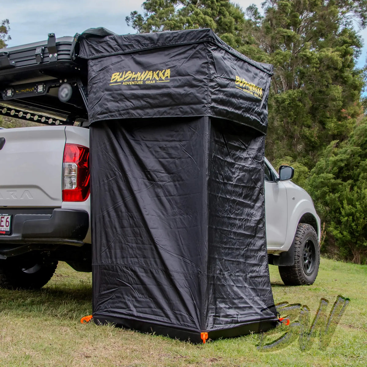 Bushwakka Extreme Shower Ensuite Single set up beside a ute with black walls pegged to the grass.