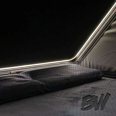 Bushwakka Nomad rooftop tent interior with mattress, pillows and LED strip.