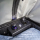 Bushwakka Stellar rooftop tent power panel close up with USB ports, a socket and an illuminated switch.