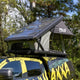 Bushwakka Stellar rooftop tent mounted on a vehicle with the clear roof raised and rain fly at the rear.