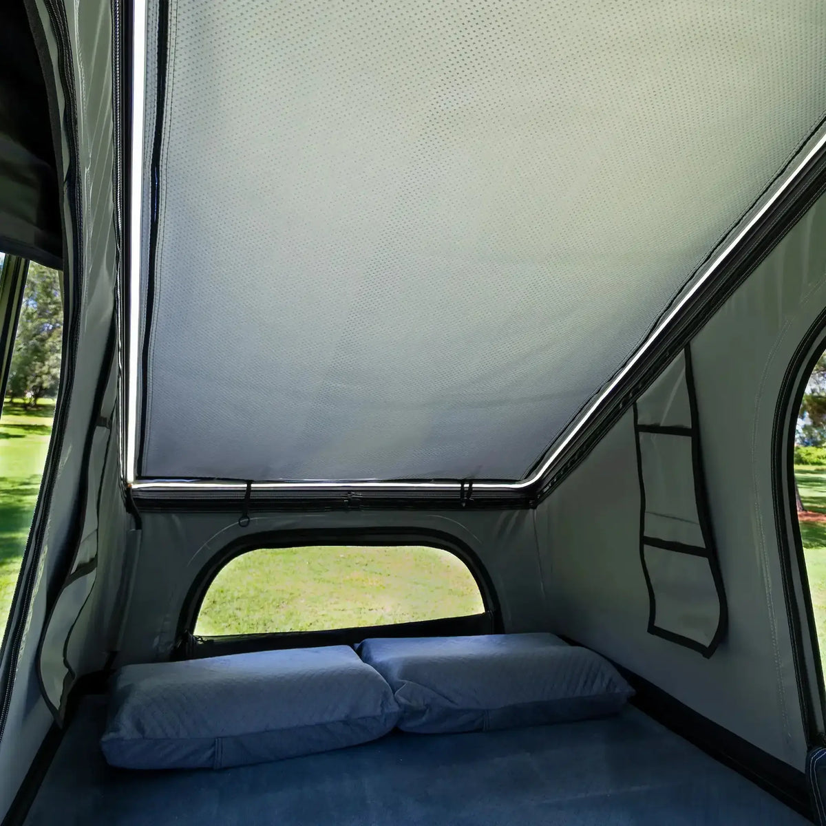 Bushwakka Stellar rooftop tent interior with the roof cover closed and a light strip along the frame.