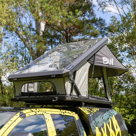 Bushwakka Stellar rooftop tent front view with the clear roof raised above the vehicle.
