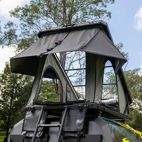 Bushwakka Stellar rooftop tent rear view with the rain fly extended above the entrance and ladder.