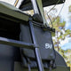 Bushwakka Stellar rooftop tent shoe bag beside the ladder with the BW logo and buckle straps.