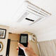 Dometic FreshJet Electronic ADB remote control held below the ceiling unit.