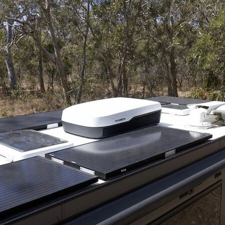 Dometic FreshJet 7 Series Plus white rooftop air conditioner installed on an caravan roof with solar panels.