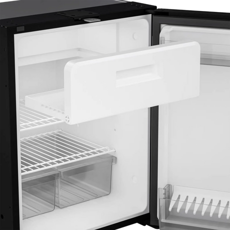 Dometic NRX 130 upright fridge interior view with freezer drawer pulled out and shelves.