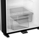 Dometic NRX 80 upright fridge lower interior view with empty wire shelves and drawers.