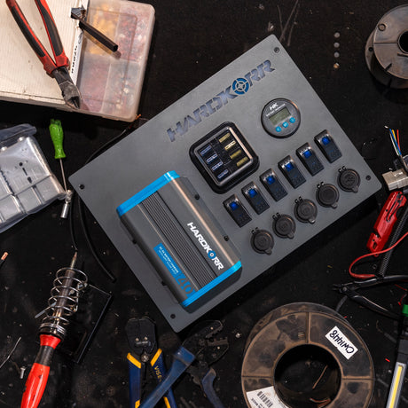 Hardkorr 12V control hub with 40A DCDC charger on a bench.