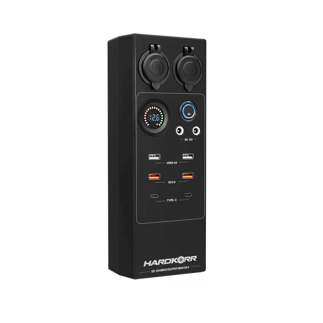 Large Hardkorr 12V DC power distribution box front view with covered sockets, a voltmeter and USB ports.