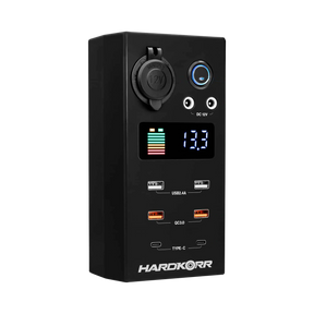 Small Hardkorr 12V DC power distribution box front view with a battery level display, USB ports and covered socket.