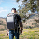 Hardkorr 15W dual USB solar device charger v2 hanging open on a hiker's backpack with solar cells facing out.