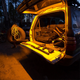 Hardkorr 1m LED tape light close up around a rear hatch, lighting the cargo area and tailgate in orange.