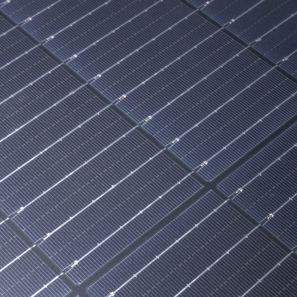 Hardkorr 200W 12V portable solar blanket solar cells in close up with fine silver lines and fabric joins.