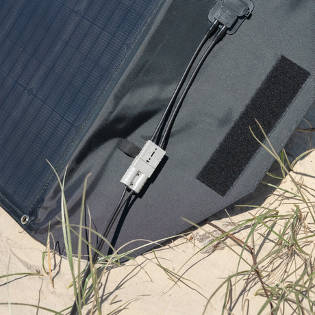 Hardkorr 200W 12V portable solar mat connector close up with an Anderson plug and paired leads on the end flap.