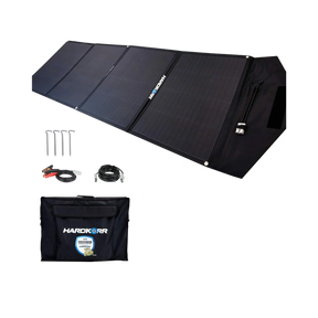 Hardkorr 200W 12V portable solar mat unfolded beside its carry bag, pegs and positive and negative battery clamp lead.