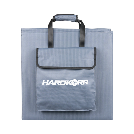 Hardkorr 250W 12V portable solar blanket folded with carry handles and a front storage pouch.