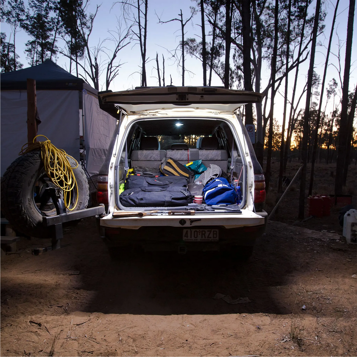 Hardkorr 2m LED tape light illuminating a vehicle's open rear cargo area with white light at dusk.