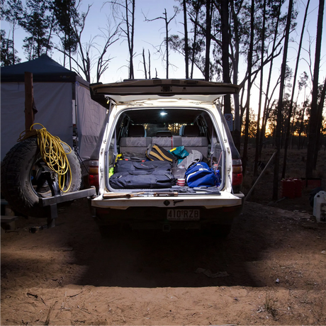 Hardkorr 2m LED tape light illuminating a vehicle's open rear cargo area with white light at dusk.