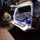 Hardkorr 2m LED tape light close up around a rear hatch, lighting the cargo area and tailgate in white.