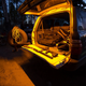 Hardkorr 2m LED tape light close up around a rear hatch, lighting the cargo area and tailgate in orange.
