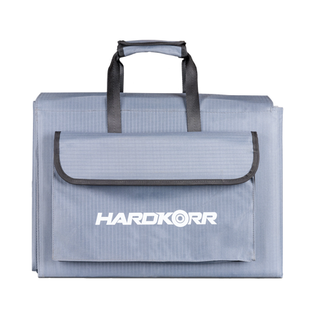 Hardkorr 300W 12V portable solar blanket folded with carry handles and a front storage pouch.